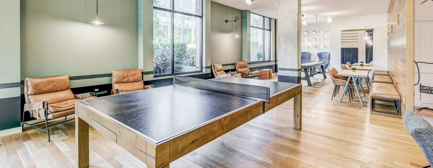 a large room with table tennis and chairs