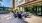 a patio with chairs and tables outside a building