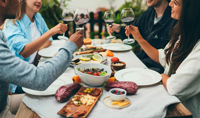 Close to the center of everything people having drinks at a dinner table